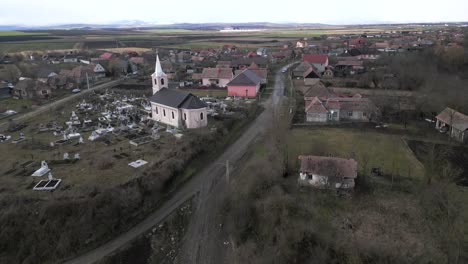 Aerial-shot-approaching-a-church-in-a-poor-village