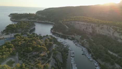Aerial-Drone-Fly-Above-Boats-Calanques-Marseille-Mountain-Sunset-River-Landscape