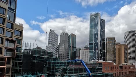 Sydney-City-Skyline-With-Tower-Crane-Deliving-Construction-Materials-On-Building-Site