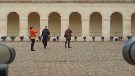Cannons-Lined-Up-in-the-Courtyard-of-Les-Invalides-in-Paris-with-People-Entering-the-Frame
