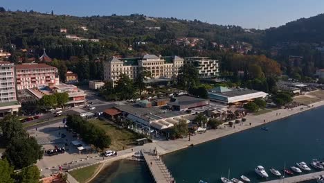 Forward-flying-drone-aerial-view-of-Trieste-shore-hotel-area,-Italy