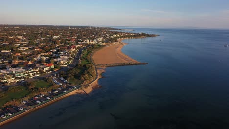 Drone-footage-flying-along-the-beach-of-Brighton-in-Melbourne,-Australia