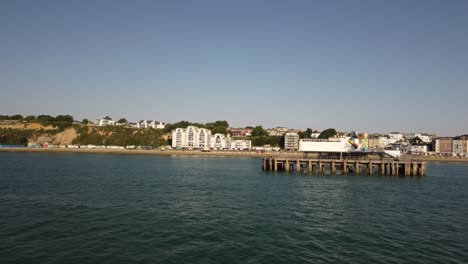 Aerial-shot-of-the-pier-and-shore-on-Isle-of-Weight-on-a-sunny-day-of-a-summer