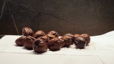 Putting-wet-walnuts-on-paper-towel,-static-close-up