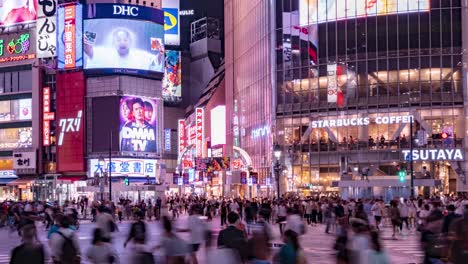 Close-Time-Lapse-of-people,-traffic,-neon-lights-at-Tokyo's-Busy-Shibuya-Crossing-at-night,-Japan-TILT