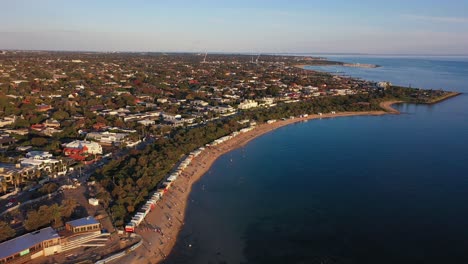 Aerial-footage-flying-along-the-beach-of-Brighton-in-Melbourne,-Australia