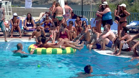 Crowded-Pool-full-of-People-Cooling-off-at-Summer-Party,-Slow-Motion