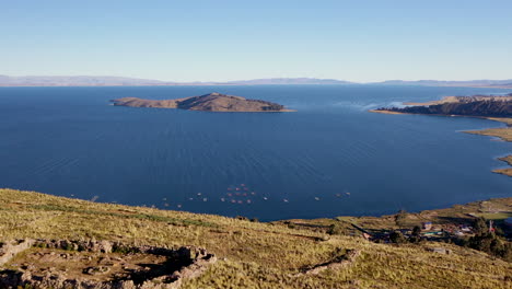 Aerial-Shot-Titicaca-Lake-Bolivian-Side-Over-Hill-Ruins-Fishermen-Boats-Island