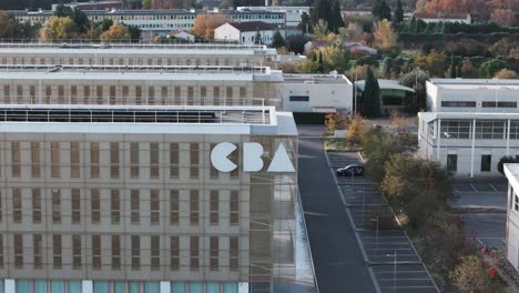 Aerial-orbiting-shot-of-the-CBA-logo-on-the-side-of-the-headquarters
