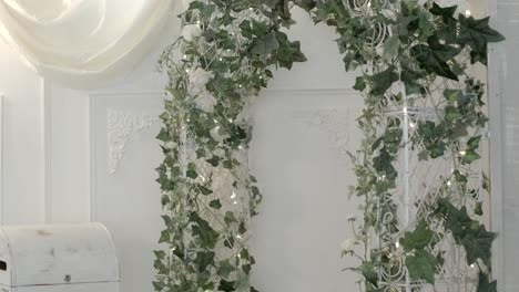 Focus-pull-to-flower-arch-for-a-wedding-ceremony-with-lights