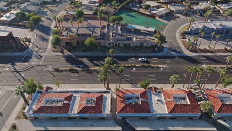 Palm-Desert,-California-drone-video-overhead-of-neighborhood-tilting-up-to-reveal-city
