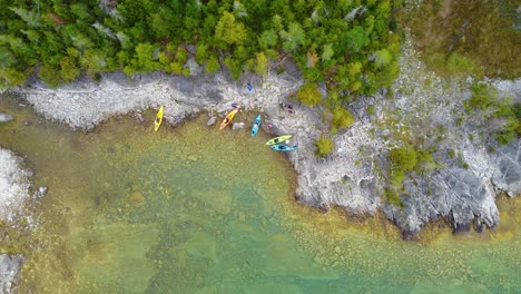 Aerial-topdown-view-of-lake-shorline-with-kayaks-at-Georgian-Bay,-Ontario,-Canada