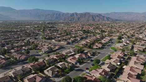 Indio,-California-neighborhood-and-mountains-with-drone-video-moving-forward