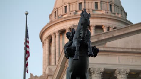 Close-up-dolly-shot-of-the-Tribute-to-Range-Riders-statue-with-the-Oklahoma-State-Capitol-building-in-the-background
