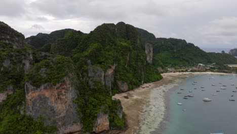 Drone-footage-from-PhiPhi-islands-in-Thailand-footage-of-incredible-Thai-landscapes-incredible-nature-with-insane-rocks,-beaches,-hills,-ocean-adn-boats