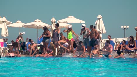 Crowded-Pool-with-People-getting-Fun-in-a-Summer-Sunny-Day,-Slow-Motion