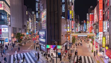 Wide-Shot-Night-Time-Lapse-of-Traffic,-Pedestrians,-neon-signs-and-lights-in-Downtown-Tokyo-Musashino-Street-In-Shinjuku,-Japan-TILT