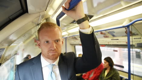 Businessman-Commuting-to-Work-on-London-Underground-Train---Handheld