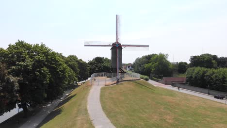 Ascending-Orbit-revealing-Tradition-Windmill-in-Bruges,-Belgium