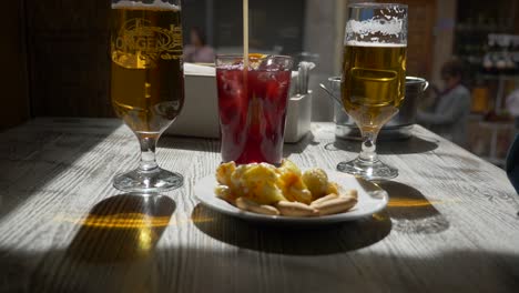 Tapas-An-Einer-Tischbar-Mit-Zwei-Bieren-Und-Einem-Tinto-De-Verano-Essen