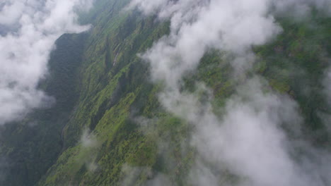 Aerial-shot-of-green-hills-covered-by-fog,-Adventurous-landscape-at-Nepal-4K