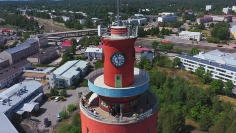Visitors-Enjoy-Grand-Views-from-Hanko-Tower,-Uusimma,-Suomi,-Finland,-Aerial-tilt