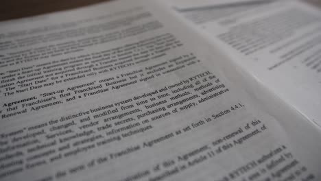 Close-up-of-a-contract-agreement-paper---Tracking,-slow-motion-shot
