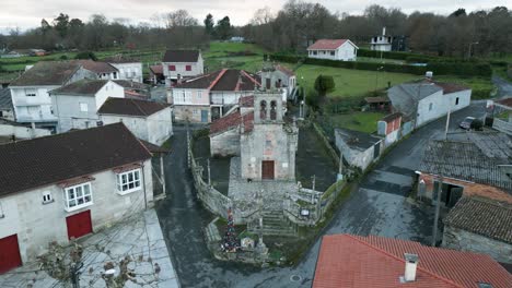 Drone-establish-view-of-old-church-in-Spanish-countryside-with-stone-bell-tower-front-entrance