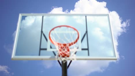 Big-white-clue-sky-cloud-against-unfocused-playground-basketball-hoop