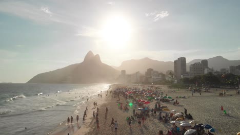 Drone-flies-above-people-playing-beach-soccer-and-sunbathing-in-Copacabana,-Rio-de-Janeiro,-Brazil