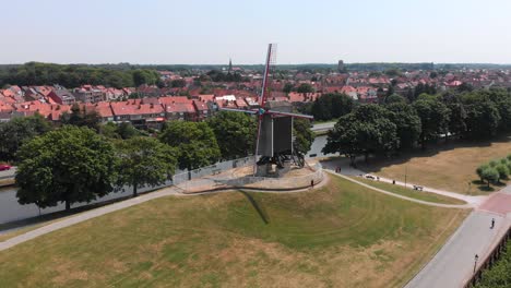 Descending-Aerial-Orbit-around-Tradition-Windmill-in-Bruges,-Belgium
