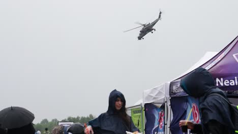 Military-attack-helicopter-perform-circle-maneuver-during-public-airshow