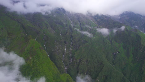 wide-drone-shot-revealing-landscape-of-green-hills,-clouds,-waterfalls-heavenly-Nepal-4K