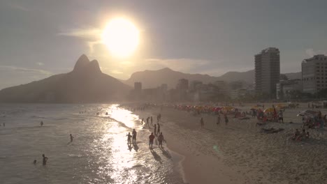 Drone-flies-over-Brazilian-beach-in-Rio-de-Janeiro-with-Sugarloaf-Mountain-on-the-background