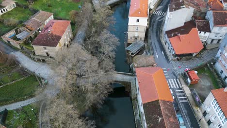 Drone-aerial-ascend-above-Roman-bridge,-river-molgas-Ourense-Spain