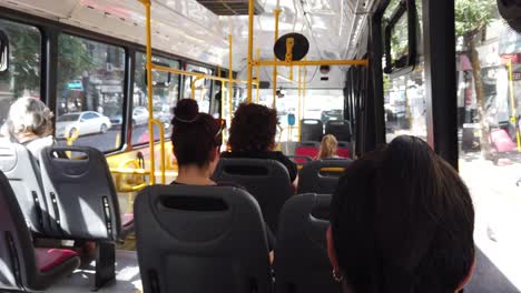 People-Travel-inside-City-Bus-Public-Transportation-Sit-Talk-on-Phone-at-Latin-America