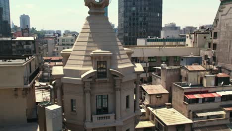 Aerial-view-dolly-in-from-the-balcony-at-the-top-of-the-Ariztia-building-on-Nueva-York-street-in-Santiago,-Chile