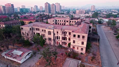Bird's-eye-view-of-dolly-in-the-abandoned-building-of-the-former-maternity-hospital-barros-luco,-Santiago-Chile-at-dusk