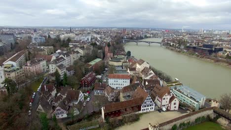 Elevate-your-perspective-with-an-aerial-view-of-Basel,-tracing-the-Rhine's-charming-housing-borders