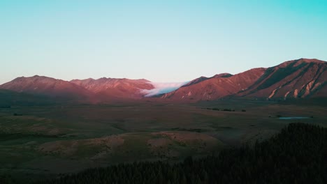 Drone-dusk-rolling-clouds-over-mountain-range-sunset-New-Zealand