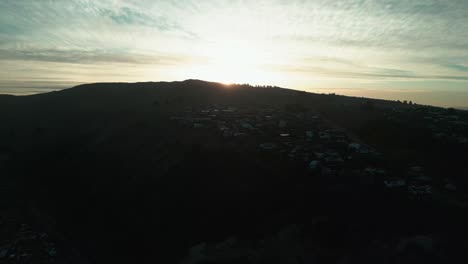 Drone-sunset-reveal-behind-mountain