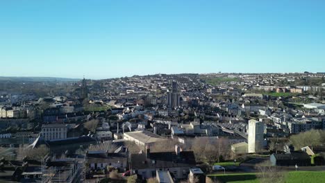 An-aerial-liftoff-with-drone-above-Cork-City-in-winter-sunny-day-with-rooftops-and-church-towers