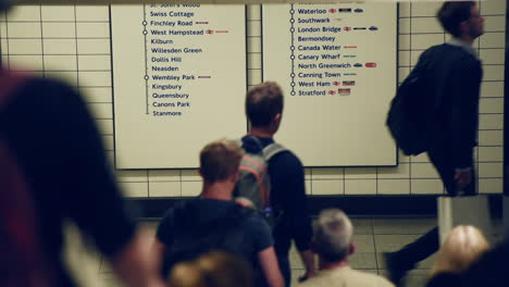 Commuters-Rushing-Down-The-Stair-In-The-Underground-Station-In-London,-United-Kingdom---high-angle-slowmo-shot