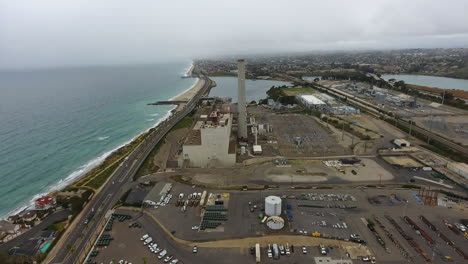Cinematic-drone-shot-of-smokestack-at-the-NRG-Encina-Power-Plant-on-the-coast-of-Carlsbad,-CA