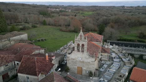 Drone-push-in-establish-old-church-in-foothills-of-Ourense-with-cemetery-around