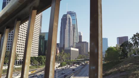 Downtown-Los-Angeles,-View-Behind-Overpass-Bridge-Fence