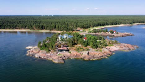 Aerial-view-away-from-a-famous-mansion-on-Stora-Tallholmen-island,-in-Hanko,-Finland---Pull-back,-drone-shot
