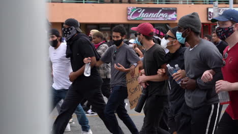 Black-Lives-Mater-Protest,-People-Walking-Hand-in-Hand-on-Streets-of-Los-Angeles-California-USA