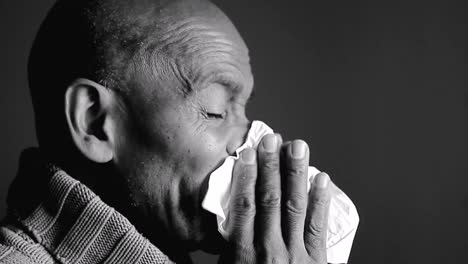 catching-the-flu-man-blowing-nose-with-allergy-sneezing-after-catching-a-cold-with-grey-background-with-people-stock-video-stock-footage