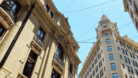 Truck-right-establishing-of-the-New-York-architecture-of-downtown-Santiago,-Ariztía-Building-and-the-stock-exchange,-Chile---Hanging-cables